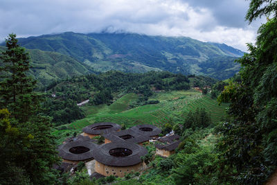 High angle view of green landscape against sky