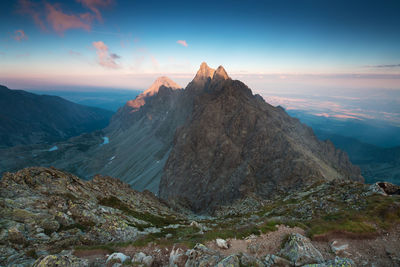 Scenic view of rocky mountains against sky during sunset