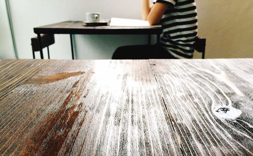 Woman holding hands on table