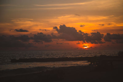 Scenic view of sea against orange sky