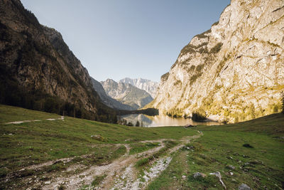 Scenic view of landscape and mountains against clear sky