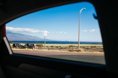 Close-up of road seen through car window