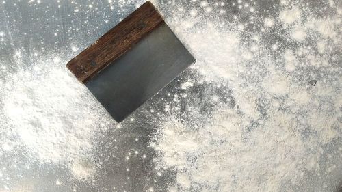 Low angle view of raindrops on wood against sky