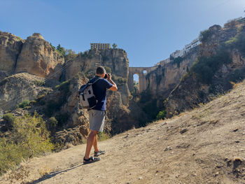 Rear view of man standing on mountain