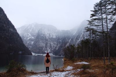 Rear view of a woman overlooking calm lake