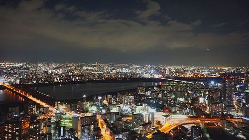 High angle view of city lit up at night