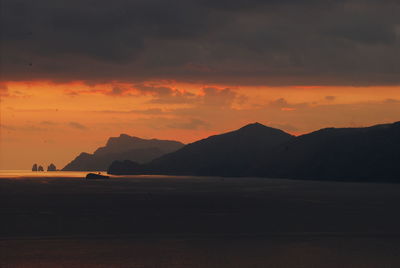 Silhouette of mountains and sea at sunset