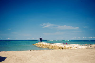 Scenic view of beach against blue sky