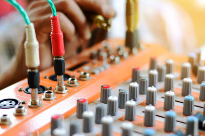 Close-up of human hand adjusting sound mixer