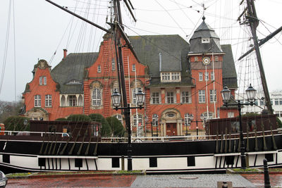 View of canal by buildings against sky