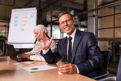 Portrait of businessman working at table