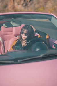 Portrait of young woman in car