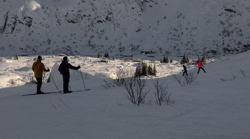 People skiing on snow covered land
