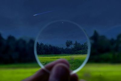 Close-up of hand holding moon against clear sky