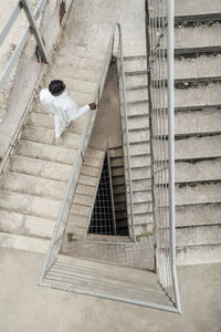 Man moving down on staircase