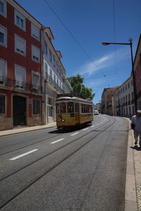 Car on street against buildings in city