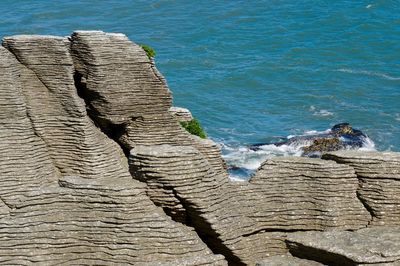 High angle on beach and cliff with geological formations