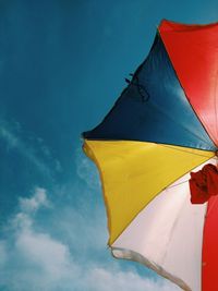 Low angle view of flag against blue sky