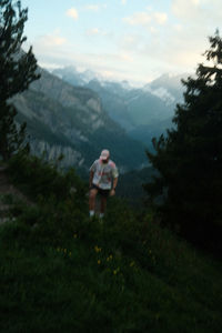 Rear view of woman walking on field