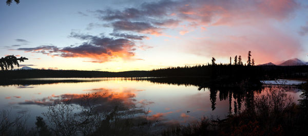 Scenic view of lake against sky during sunset