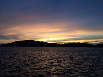 Scenic view of dramatic sky over sea during sunset