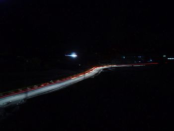 View of illuminated road at night