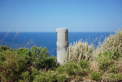 Scenic view of sea against clear blue sky