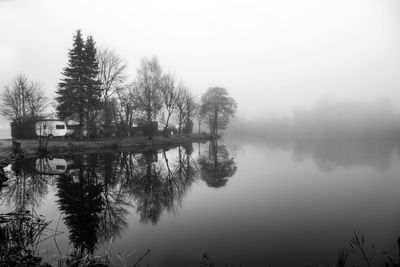 Reflection of trees in lake against sky