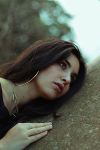 Close-up of thoughtful young woman by wall