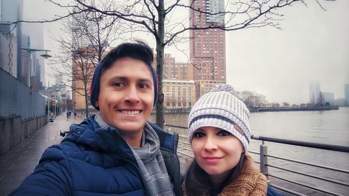 Portrait of smiling woman in city during winter