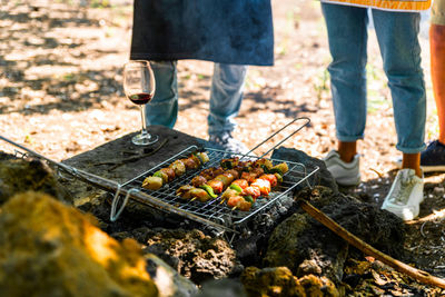 Low section of people on barbecue grill