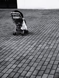Man sitting on footpath by street