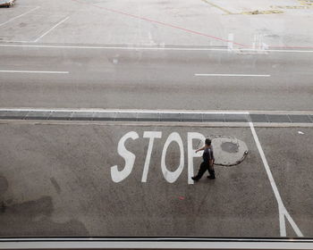 High angle view of man walking on road