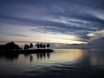 Scenic view of lake against sky at sunset