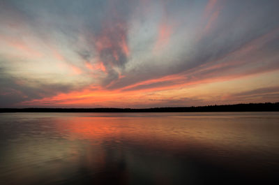 Scenic view of lake against romantic sky at sunset