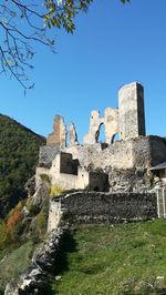 Low angle view of old ruin building against sky