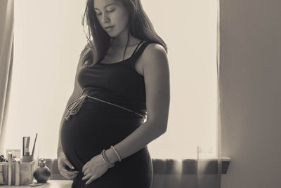 Midsection of woman standing at home