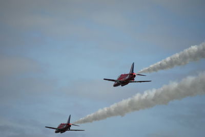 Low angle view of airshow against sky