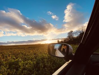 Car on road against sky during sunset