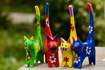 Hand made toys in intense colour yellow blue red green against flat colour background