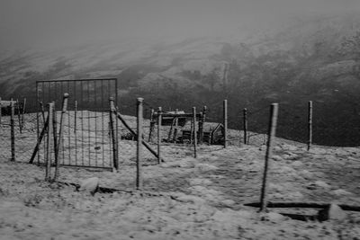 Snow on field against sky during winter