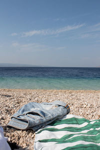 Scenic view of sea against sky and clothes on the beach 
