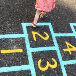 Low section of child playing on road