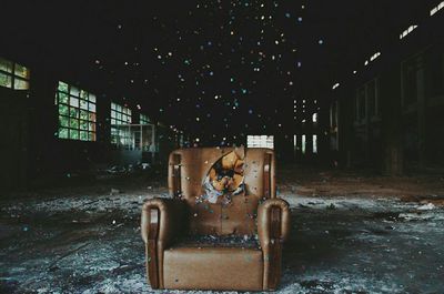 Abandoned armchair in dark room