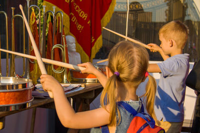 Friends playing musical instrument outdoor