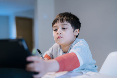 Boy looking at camera at home