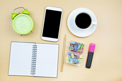 Directly above shot of various objects over yellow background