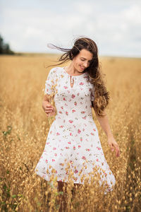 Young woman standing on field