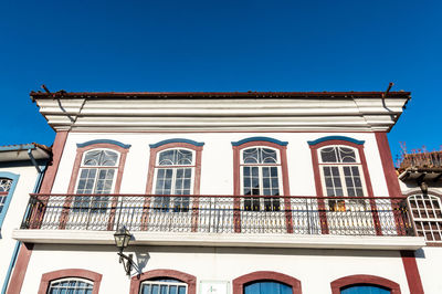 Low angle view of building against clear blue sky