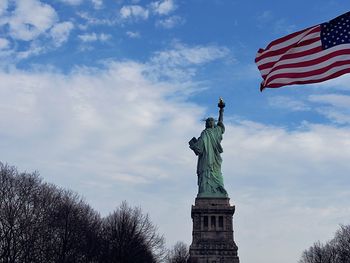 Low angle view of statue against cloudy sky